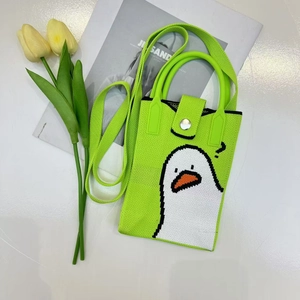 Detail of neon green knit phone bag with white cartoon duck and long shoulder strap
