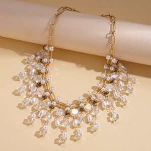 Detailed view of vintage layered necklace with gold chains, pearls, and crystal tassels