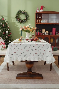 Christmas cotton tablecloth detail showing red berry print and ruffle edge on a dining table