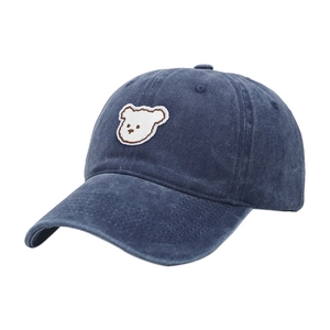 Navy blue baseball cap with cute white bear embroidery in a classic washed cotton style