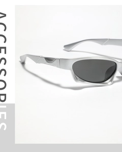 Close-up of silver futuristic Y2K sunglasses with sleek streamlined frame and dark lenses