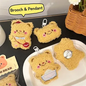 Cute brown plush bear brooch and keychain pendant with blue and red bag details
