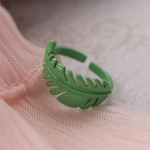 Macro shot of green enamel leaf ring showing detailed plant veins and adjustable band