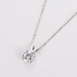 Macro view of silver V-shape four-prong set cubic zirconia pendant on O-chain necklace