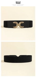 Close-up of black elastic wide belt featuring vintage golden interlocking C buckle design