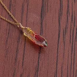 Detail of wire-wrapped bullet crystal pendant necklace in red-yellow gradient
