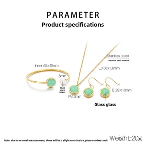 Detail view of gold stainless steel jewelry set with green glass and shell pearls