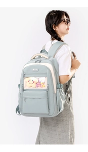 Detailed side view of light blue nylon backpack with transparent window on model