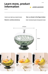 Detail view of light luxury striped fruit plate with silver bear handle and PP material