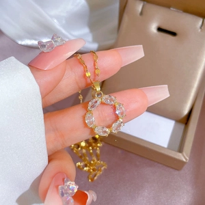 Minimalist gold titanium necklace featuring a circle pendant set with oval cubic zirconia