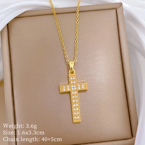 Detailed view of 3.6g gold cross necklace pendant with dimensions 1.6x3.3cm on silk