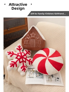 Decorative Christmas plush pillows featuring gingerbread house, red snowflake, and candy swirl