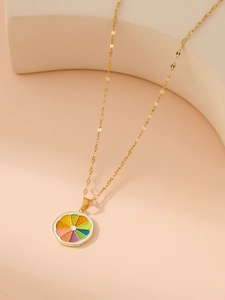 Close-up of golden necklace with a colorful lemon slice pendant in enamel finish