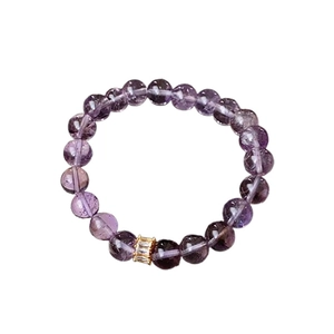 Elegant purple amethyst beaded bracelet with gold-plated zircon spacer bead on white background