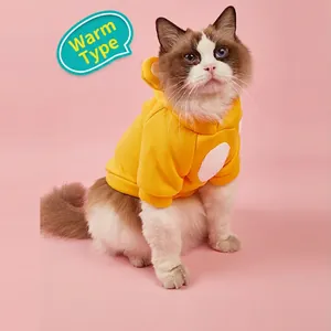 Cute yellow hooded pet sweater with ears for small dogs and cats on pink background