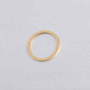 Close-up of a 25mm polished golden stainless steel flat ring with mirror finish details