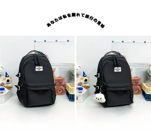 Detail view of black minimalist backpacks with brand labels and plush puppy keychain