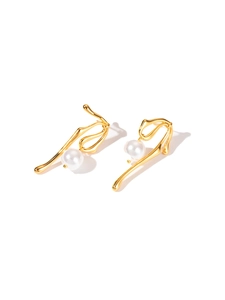 Detail of gold titanium steel earrings featuring artistic curves and white pearls