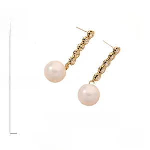 Macro detail of elegant drop earring with sparkling rhinestones and a 1.5cm white pearl