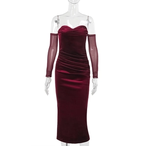 Detail of burgundy velvet dress with ruched texture and matching mesh long sleeves