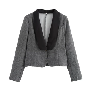 Detail of grey herringbone blazer with contrast black lapel and single button closure