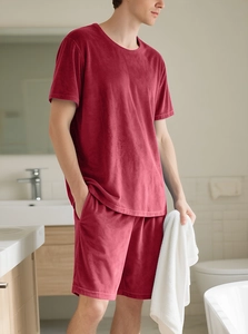 Detailed texture of burgundy velvet lounge set for men on a model in bright bathroom