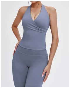 Close-up of gray-blue V-neck halter yoga top with cross-wrap design and matte texture