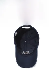 Detail of blue cotton baseball cap interior showing stitching and adjustable strap