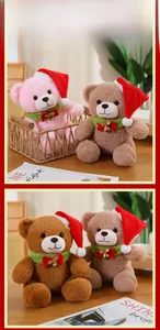 Detail of plush Christmas teddy bears with red hats and green bells in warm setting