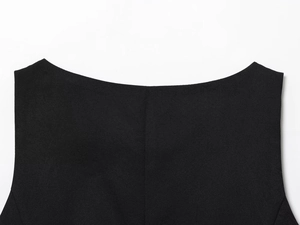 Detailed close-up of the woven black sleeveless top neckline showing high-quality fabric texture