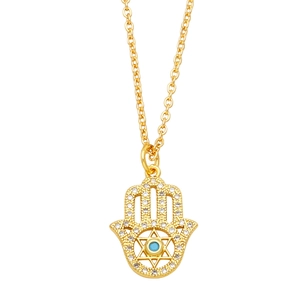 Gold Hamsa Hand necklace featuring pavé zircon and a central blue turquoise bead