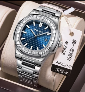Macro shot of silver steel watch with blue textured dial and diamond-set bezel