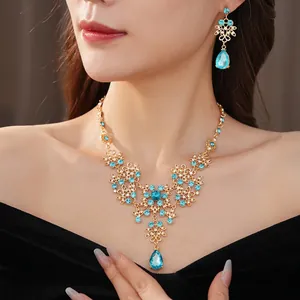 Vintage gold necklace and earring set with blue zircon flower and waterdrop pendants