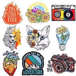 Collection of nine colorful embroidered patches with diverse creative designs for DIY clothing