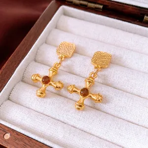 Vintage gold cross earrings with amber gemstones displayed in a jewelry gift box