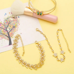 Three-piece gold-tone jewelry set with butterfly, leaf, and star zircon bracelets