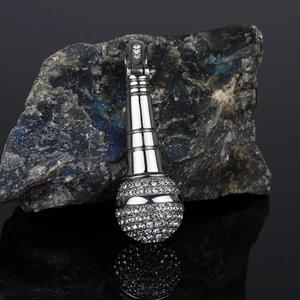 Macro shot of silver hip-hop microphone pendant with sparkling white rhinestones