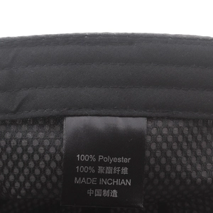 Macro detail of breathable black mesh interior and material label on baseball cap