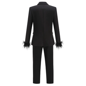 Rear view of black women suit set featuring feather cuffs and straight-leg trousers
