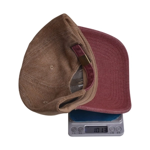 Close-up of vintage denim baseball cap with metal buckle on a scale weighing 101.3g