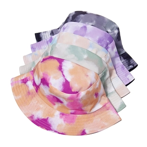 Detailed view of tie-dye bucket hats showing thick cotton twill texture and stitching