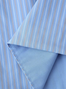 Macro shot of light blue striped cotton fabric with fine stitching and soft textures