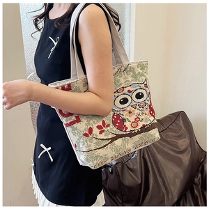 Detailed close-up of woven owl jacquard pattern on a large canvas tote bag