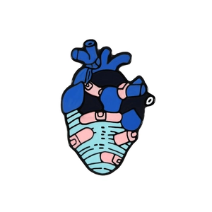 Artistic blue anatomical heart enamel pin with pink bandage detail on white background