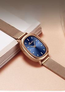 Detailed 45-degree close-up of oval rose gold quartz watch with blue sunray dial
