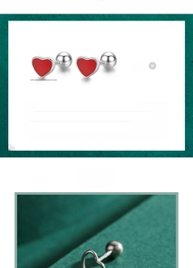 Macro detail of red heart S925 sterling silver stud earrings with screw back design
