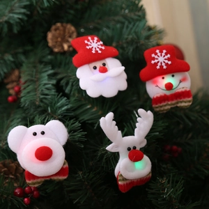 LED Christmas brooches with Santa, snowman, and reindeer figures on a festive tree branch