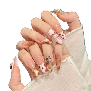 Pink leopard print press-on nails with 3D bows and rhinestones on almond shape