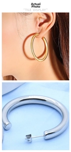 Detailed close-up and model view of thick C-shape hoop earrings in gold and silver