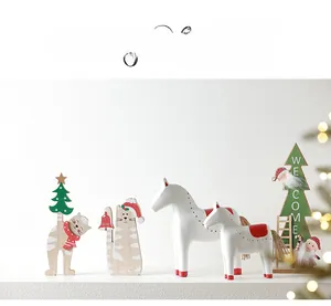Close-up of wooden Christmas tabletop decor with Welcome sign and painted rocking horse